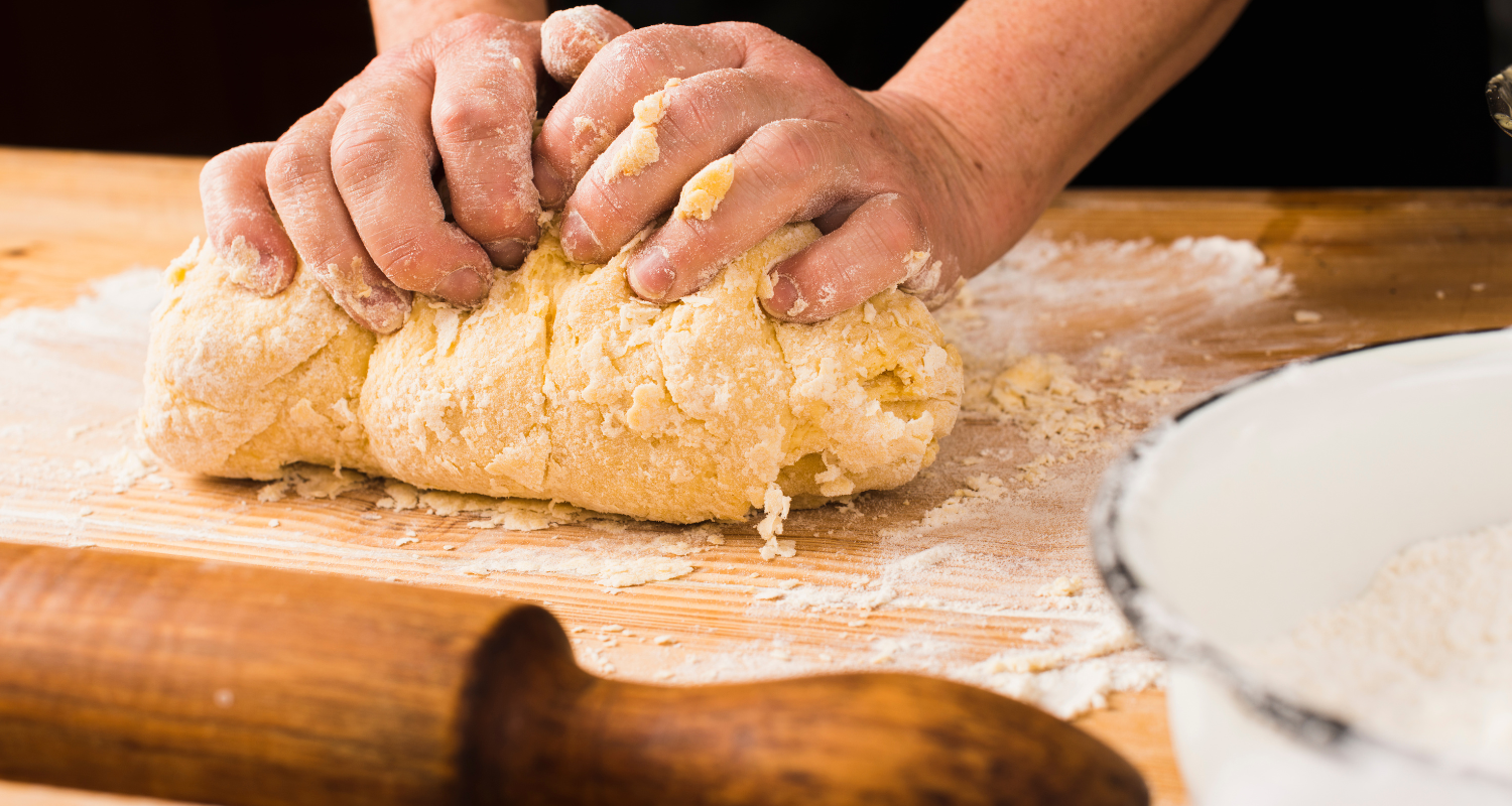 Elegant baking scene showcasing the art of making puff pastry on a marble kitchen countertop, with rolling pin and golden-brown pastries