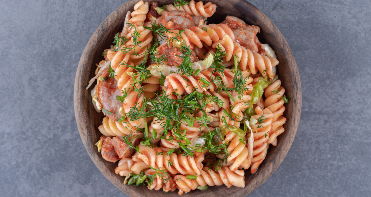 Delicious kielbasa pasta recipe served on a rustic wooden table, perfect for any occasion.