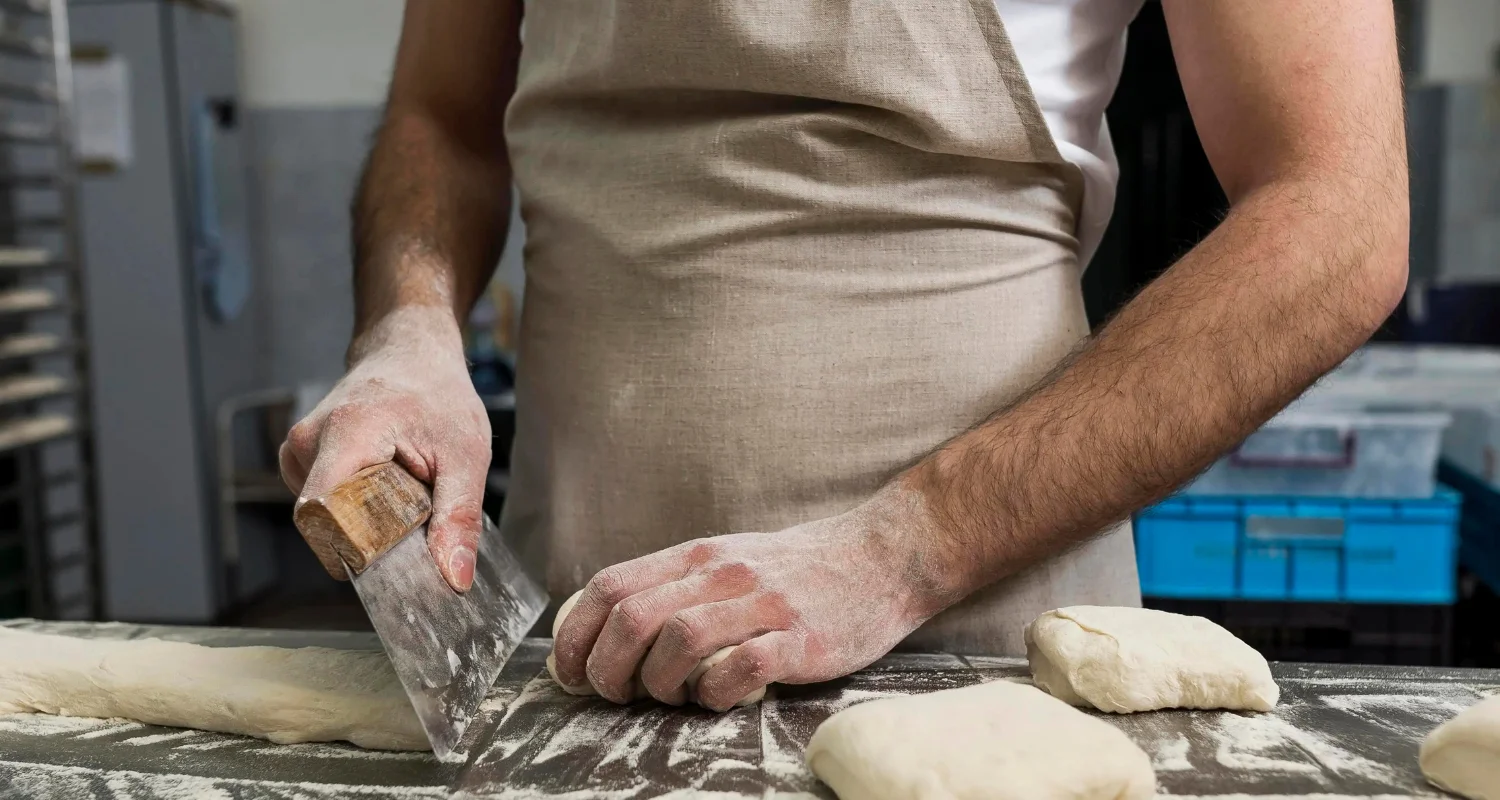 Warm kitchen scene with golden, flaky puff pastry showcasing its buttery layers on a rustic wooden table.