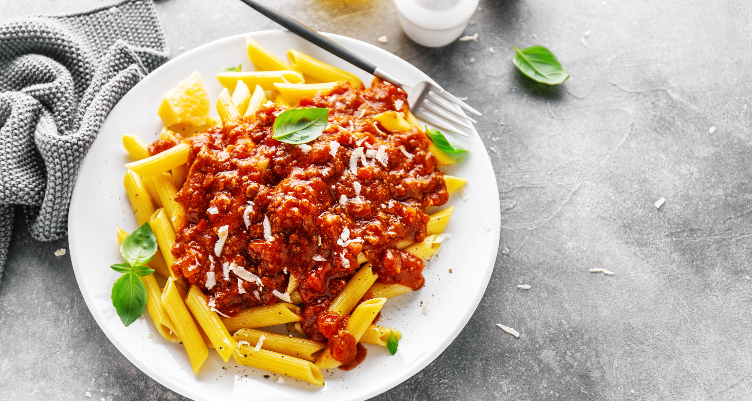 Close-up of a rich and flavorful sausage pasta meal, highlighting the vibrant ingredients and savory sauce.