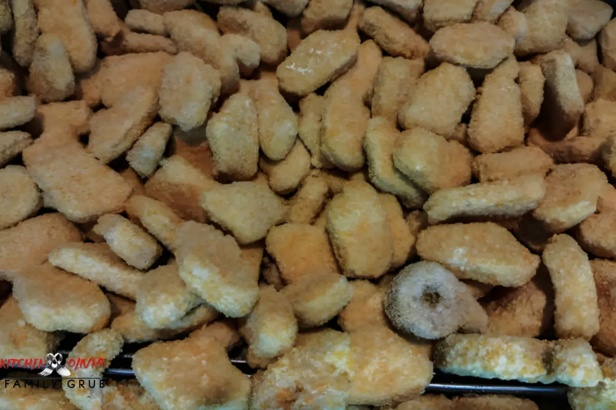 Packaged frozen chicken nuggets on a supermarket shelf