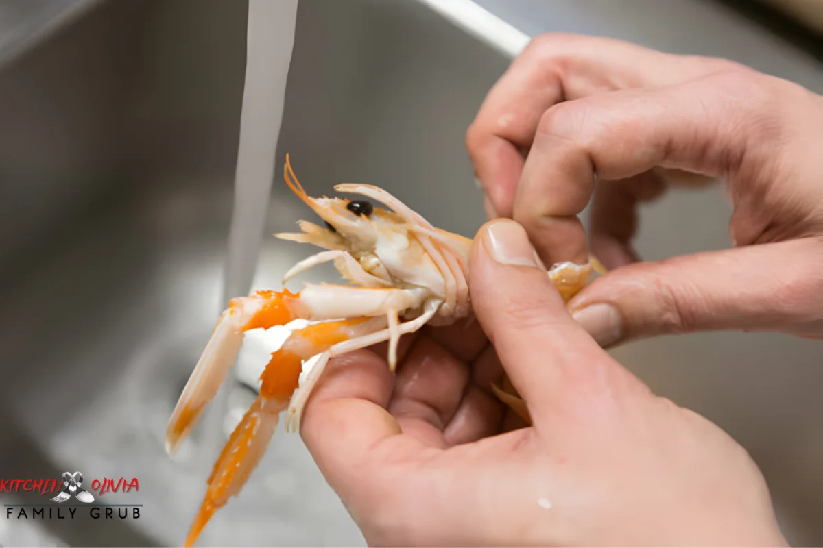 Hands cleaning and deveining fresh shrimp