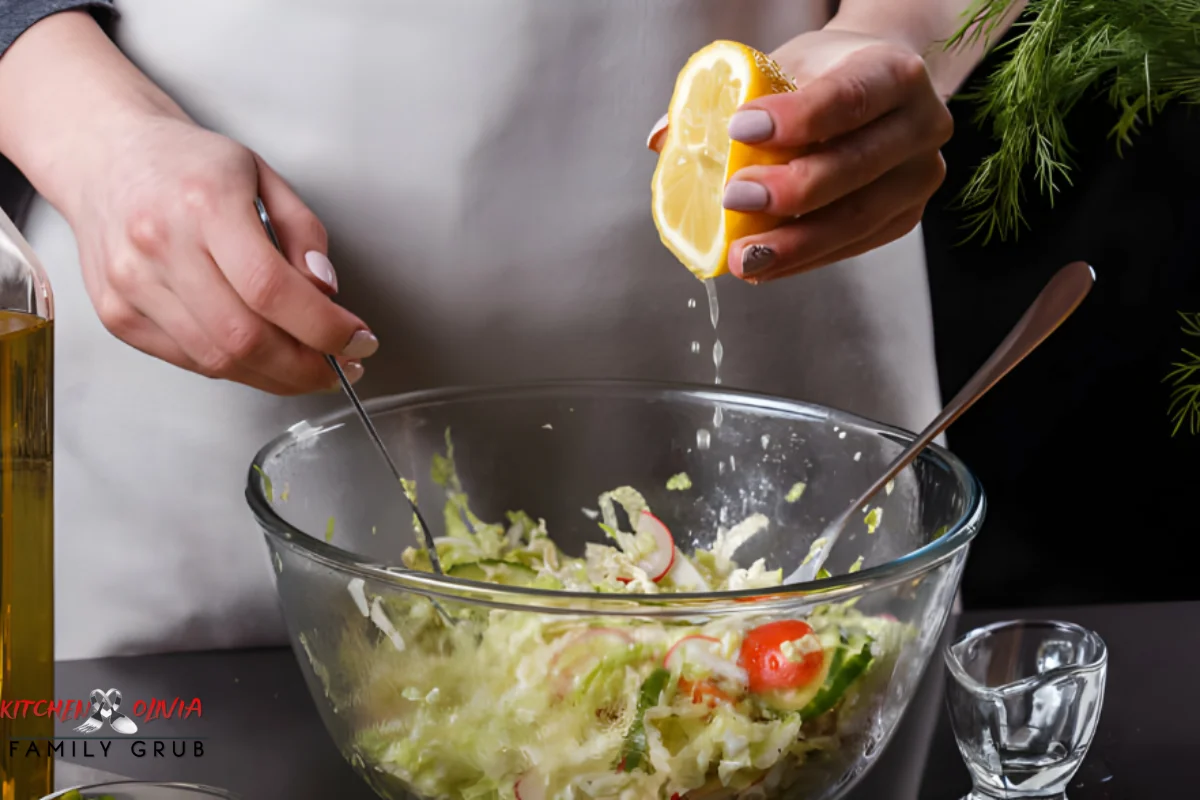 Hand mixing salad dressing in a glass jar with fresh ingredients