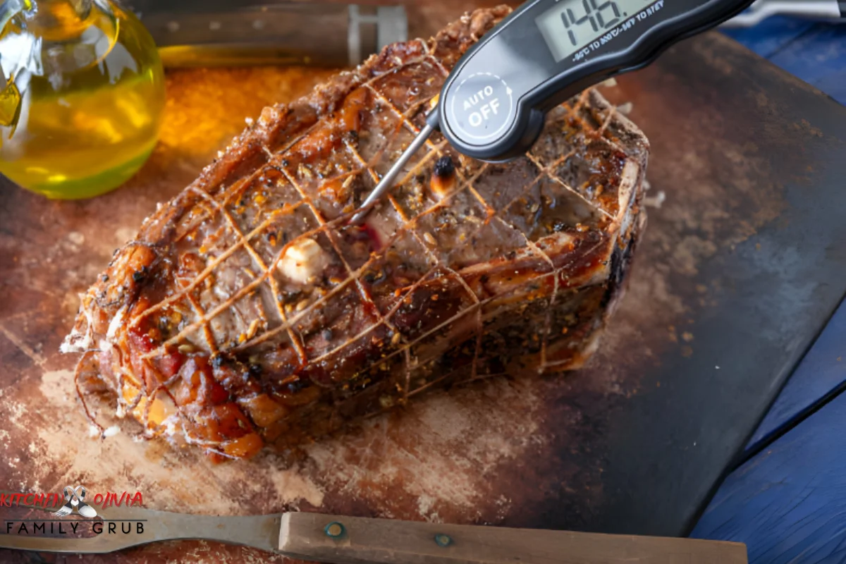 Checking smoked meatloaf temperature with a meat thermometer